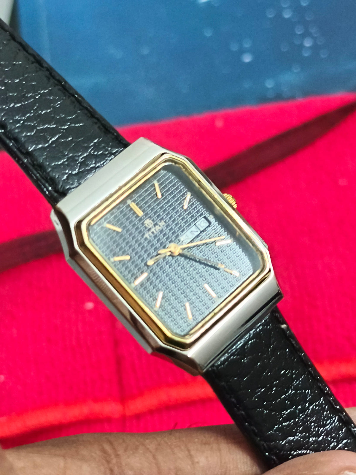 Titan Tank Quartz Day Date Watch with a Two Tone Case and Textured Black Dial