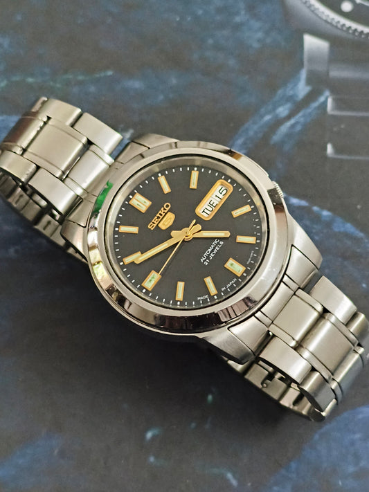 Seiko 5 Automatic Day Date Dual Toned Watch with a Black Dial Featuring Lumed Golden Hands and Indices (Transparent case back)