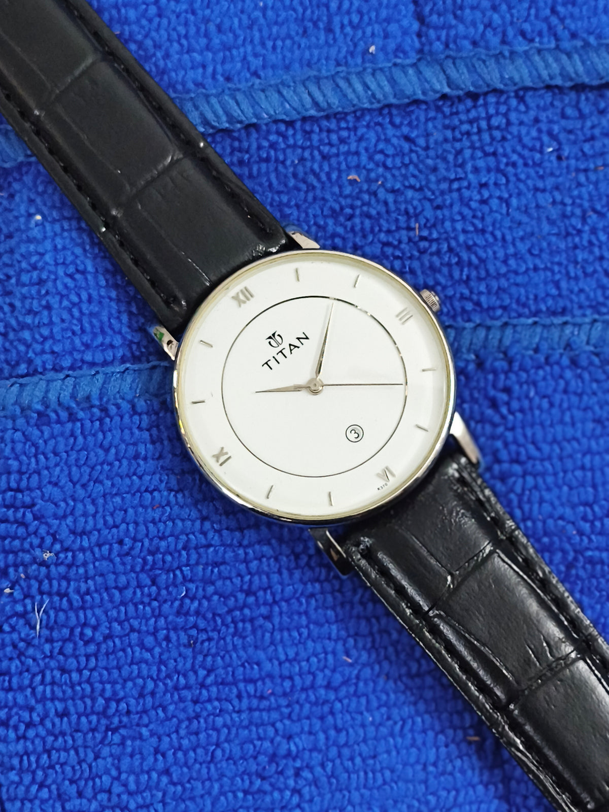 Titan Quartz watch with a White Dial and Roman Numerals