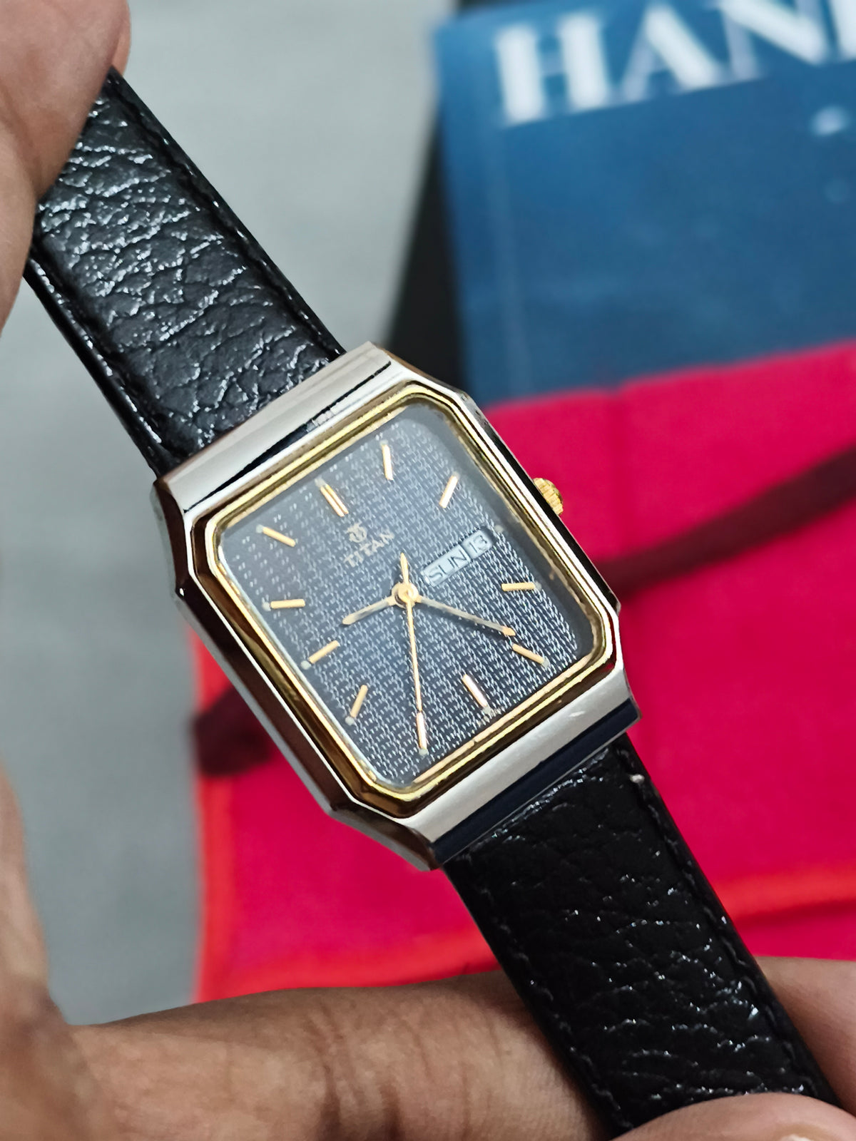 Titan Tank Quartz Day Date Watch with a Two Tone Case and Textured Black Dial