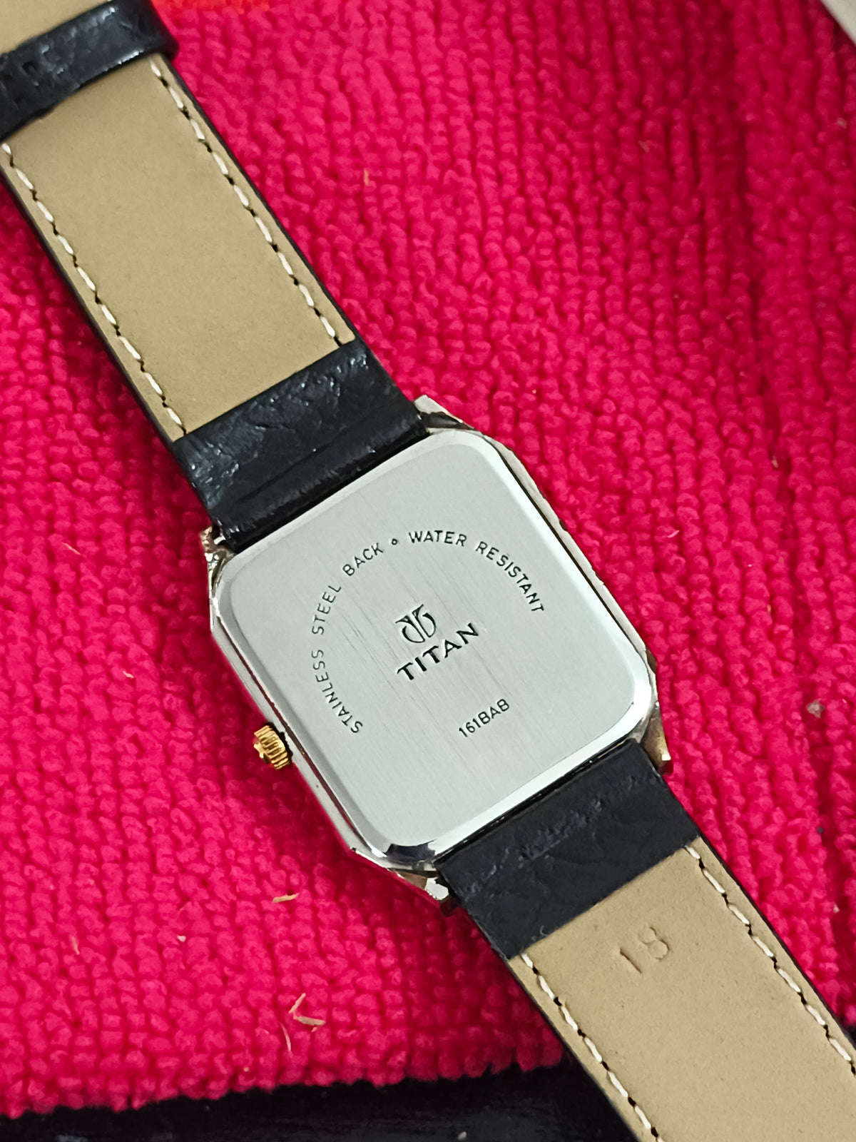 Titan Tank Quartz Day Date Watch with a Two Tone Case and Textured Black Dial