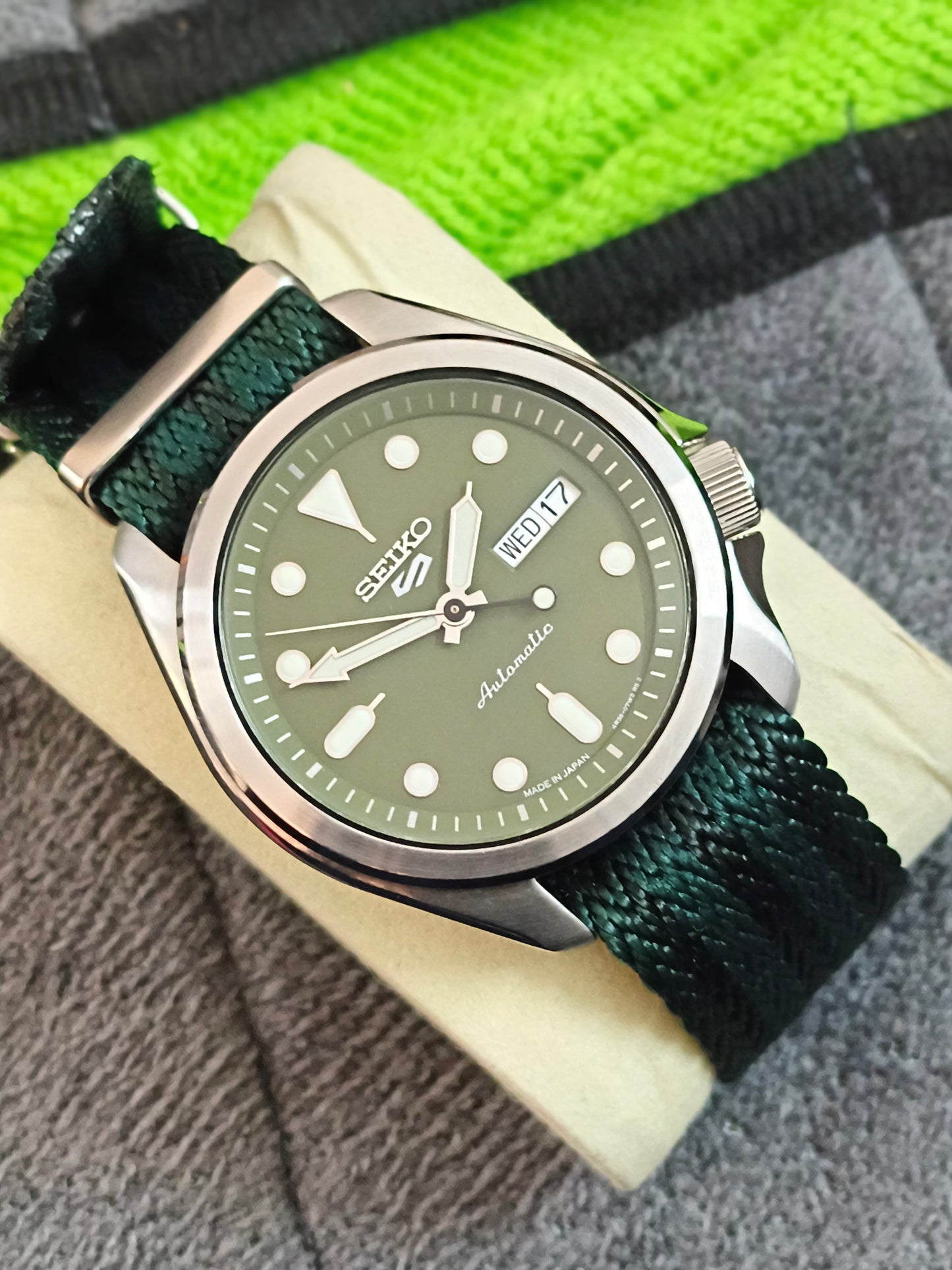 Seiko 5 Sports SKX Series Model SRPE65 with a Green Dial and Matching NATO Strap